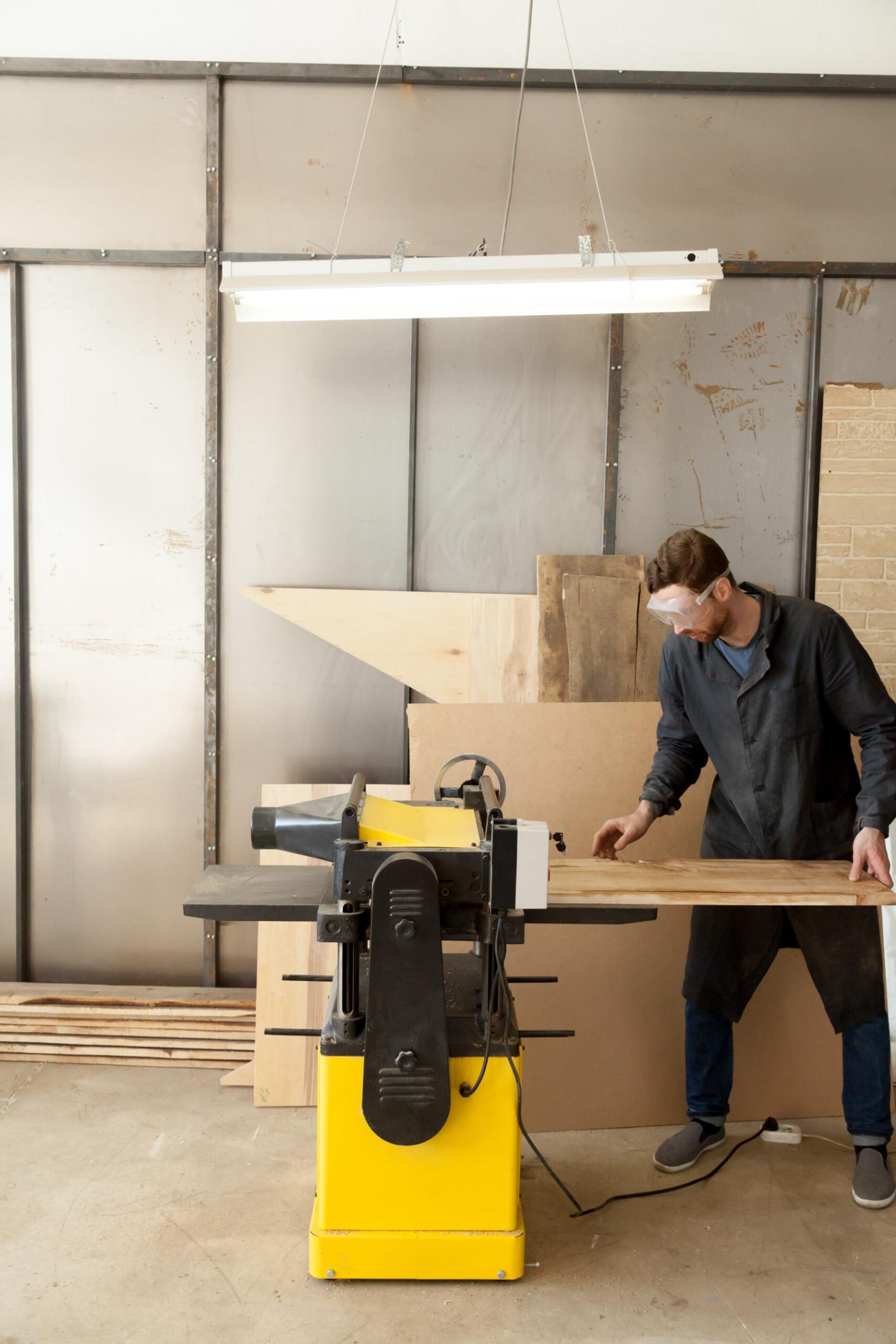 skilled carpenter working machine tool scaled